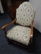 A 20th century beech armchair upholstered in tapestry fabric.