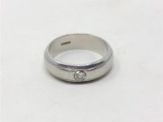 A platinum band ring set with a diamond, size N/O, 10.4g, approximately 0.2ct.