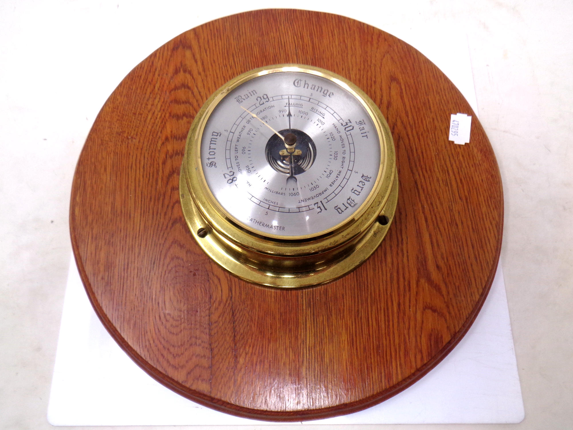 A Weathermaster barometer mounted on a board.