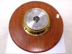 A Weathermaster barometer mounted on a board.