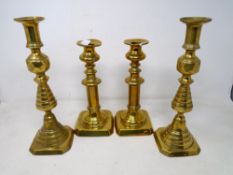 Two pairs of 19th century brass candlesticks.