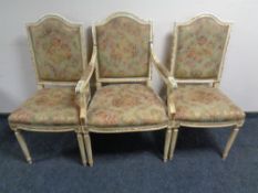 A set of six cream and gilt French style dining chairs, two carvers and four singles,