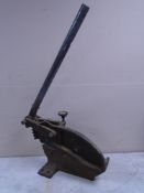 A vintage manual metal cutter.