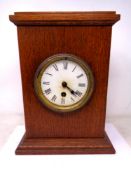 An Edwardian oak cased mantel clock.