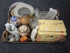 A box containing assorted ceramics, drinking glasses, boxed Pyrex dishes.