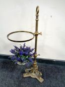 A 19th century brass rise and fall plant stand on ornate base (height 67cm).