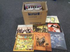 A box containing vinyl LPs including The Pogues, Donna Summer, The The, Metallica,