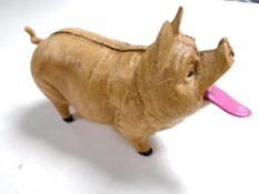 A cast iron coin-eating pig money box.