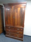 A late Victorian walnut double door linen press fitted with internal trays with four drawers