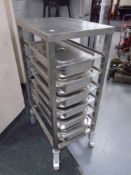 A stainless steel Bain Marie trolley together with six Bain Marie pots with lids.