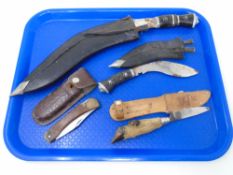 A tray containing two Kukri knives in sheaths together with a folding pocket knife in sheath and a