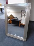 A contemporary bevel edged overmantel mirror in silvered frame.