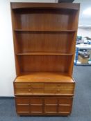 A 20th century set of Nathan teak bookshelves fitted with double door cupboard and four drawers