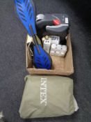 A box containing skateboard, shoe cleaning creams, Intex air bed, clock radio etc.