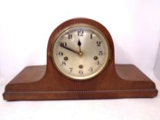A 1930's oak cased Westminster chime mantel clock with silvered dial on bun feet.