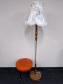 A mid-20th century standard lamp with shade together with a footstool on raised legs upholstered in