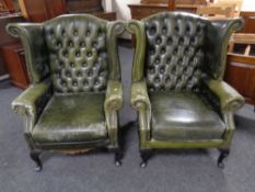 A pair of green leather Chesterfield wingback armchairs (as found)