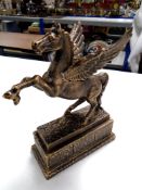 A cast iron figure, Pegasus, on plinth.