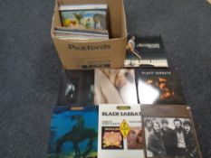 A box containing vinyl LPs including The Band, Black Sabbath, Bat 4 Lashes, The Beach Boys etc.