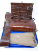 A tray containing two vintage crocodile leather handbags together with a leather belt with brass