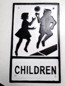 A cast iron wall plaque, children playing.