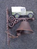 A cast iron Land Rover wall bracket with bell.