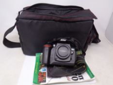 A Nikon D70 camera in bag with accessories including lens.