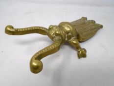 A 19th century brass beetle bootjack