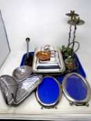 A tray containing assorted plated ware, a pair of metal candlesticks, photo frames,