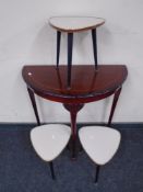 An inlaid D-shaped hall table in a mahogany finish together with three mid-20th century melamine