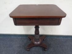 A Victorian pedestal occasional table with a fitted drawer.