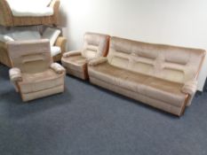 A three piece mid-20th century teak framed lounge suite upholstered in brown fabric.