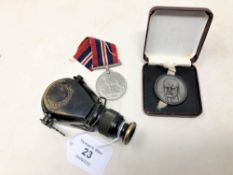 A WWII War Medal, Churchill commemorative medallion and a reproduction German brass naval monocular.