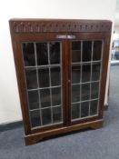 An Edwardian oak double door bookcase with leaded glass doors.