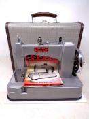 A vintage Essex miniature sewing machine with instruction booklet, cased.