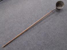 An antique long-handled smelters ladle (length 190cm).