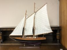 A hand crafted wooden boat on stand,