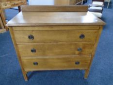 An Edwardian oak three drawer chest.
