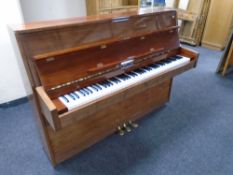 An Osztreicher overstrung piano in gloss finish case, with key.