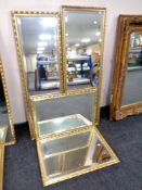 Two bevel edged hall mirrors together with two further bevel edged wall mirrors, all in gilt frames.