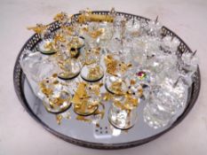 A mirrored gallery tray together with a collection of assorted crystal ornaments including an