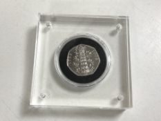 A commemorative Kew Gardens 50p coin 2019 under perspex cover.