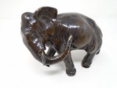 A bronze figure of an elephant.