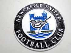 A cast iron wall plaque, Newcastle United FC crest, diameter 24 cm.