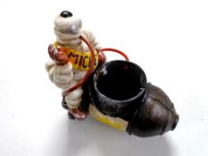 A cast iron figure, Michelin man on compressor.