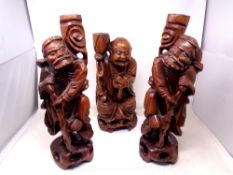 Three carved hardwood figural lamp bases of Chinese gentlemen.