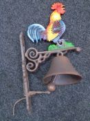 A cast iron cockerel wall bracket with bell.