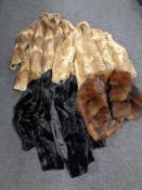 A box containing four lady's fur and simulated fur coats.