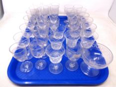 A tray containing a collection of antique etched drinking glasses.