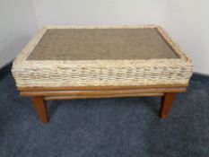 A wicker glass topped coffee table.